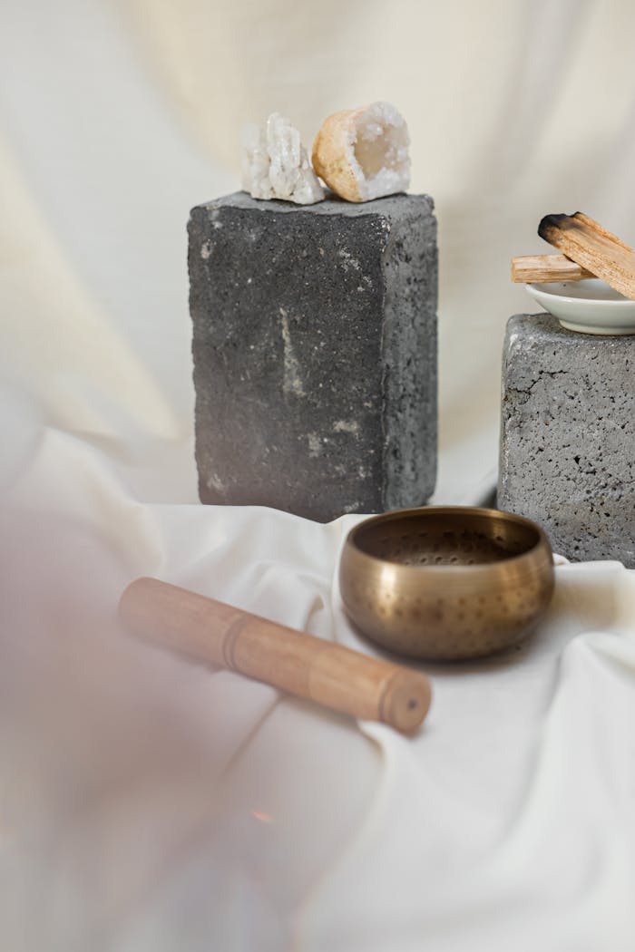 Home Tranquil setup featuring a Tibetan singing bowl, crystals, and incense for meditation and relaxation.